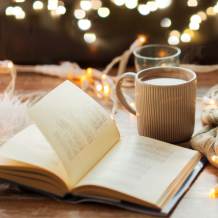A candle, a an open book, a cup of coffee, autumn vibe background