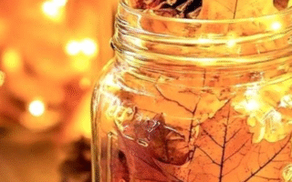 A candle with autumn leaves