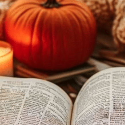 A open book, a candle, pumpkin, a cosy blanket, autumn vibe