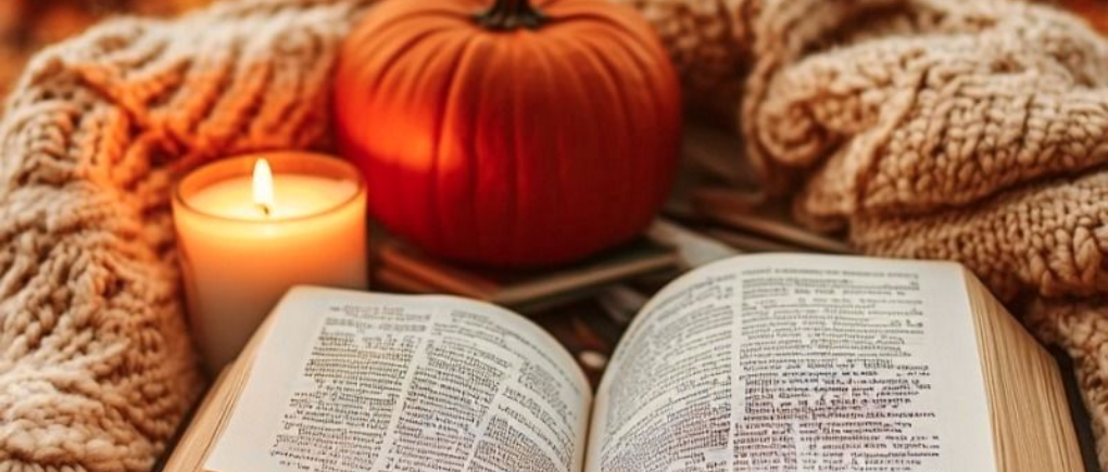 A open book, a candle, pumpkin, a cosy blanket, autumn vibe